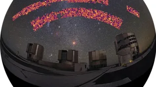 A map from the KiDS survey projected onto the sky shows 'ripples' in the distribution of matter in the far Universe, imaged by gravitational lensing. The smallest visible spots are approximately 30 million light years in size. In the foreground is the Paranal Observatory, home to the VLT Survey Telescope. Credit: B. Giblin, K. Kuijken and the KiDS team. Foreground panorama: ESO/Y.Beletsky CC BY 4.0.