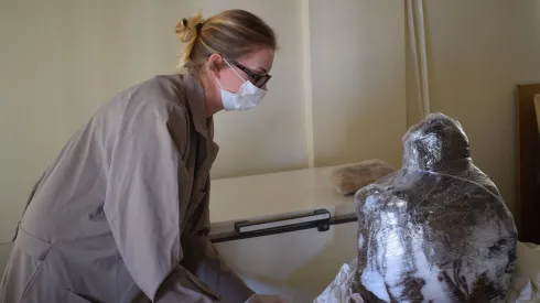 Dagmara Socha examines the mummy of a child from Ampato. Credit: D. Socha