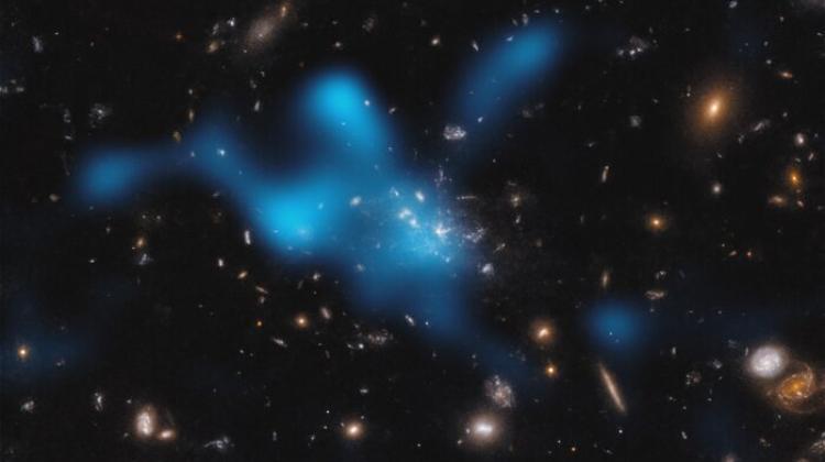 Protogromada wokół galaktyki Spiderweb (MRC 1138-262), widziana w okresie, gdy Wszechświat miał 3 miliardy lat. Większość masy protogromady nie znajduje się w galaktykach widocznych w centrum zdjęcia, ale w gazie nazywanym ośrodkiem wewnątrzgromadowym (ang. intracluster medium, ICM). Gorący gaz w ICM został tutaj pokazany jako niebieskie plamy. Źródło: ESO/Di Mascolo et al.; HST: H. Ford.